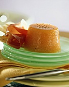 Melon pudding with prosciutto on a green plate