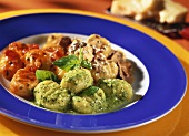 Gnocchi with three sauces on a plate