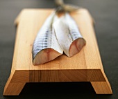 Fresh mackerel on a sushi board
