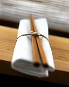White fabric napkin & chopsticks, tied with string