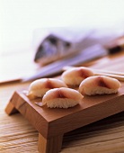 Nigiri sushi with sea bream on a sushi board