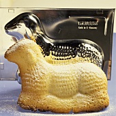 Easter lamb with icing sugar in front of baking tin