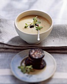 Potato soup with fried black pudding and prunes