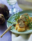 Veal rolls with artichoke stuffing on pasta