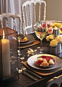 Roses as table decoration, candle and white wine glasses