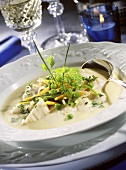 Fish soup with spring vegetables and parsley