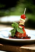 Tuna with skewered vegetables and basil in spicy sauce