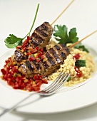 Lamb kebabs with pepper salad and couscous