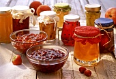Various jams and jellies in jars and bowls