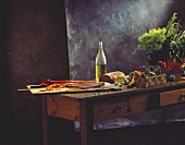 Still life: salmon, olive oil, bread & vegetables on table