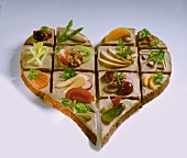 Heart made from open sandwiches with fruit and vegetables
