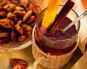 Punch with cinnamon stick and orange peel; nut crispies