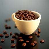 Coffee beans in yellow coffee cup