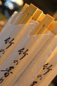 Chopsticks in white paper cases with Chinese characters