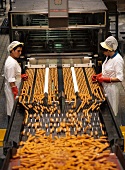 Women checking fish fingers on conveyor belt