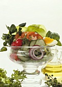 Vegetable salad with egg, lettuce & herbs in glass bowl