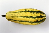 Yellow and green striped pumpkin on white background