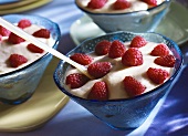 Mascarpone mousse with fresh raspberries in glass bowls