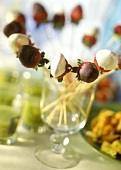 Strawberry kebabs with chocolate in a glass