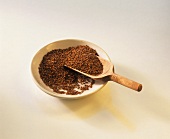 Linseed on a plate with wooden scoop