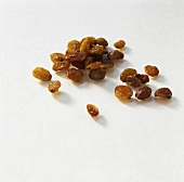 Several raisins on white background