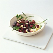 Bottled olives with onions and herbs in a bowl