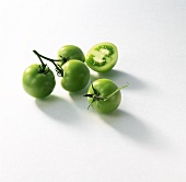 Green tomatoes, one cut in half