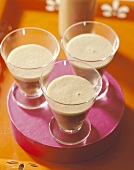 Coffee liqueur in three glasses on a tray