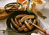 Fried sausages in the pan; Sauerkraut; Mashed potato