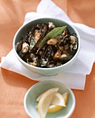 Mussels, seaman's style, with garlic and bay leaf; lemons