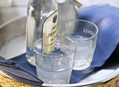 Ouzo in glasses and bottle on tray