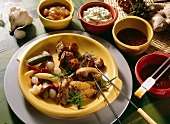 Meat and poultry fondue with mixed pickles and dips