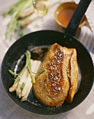 Fried foie gras with asparagus in pan
