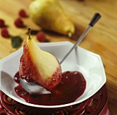 Poached pear with raspberry sauce