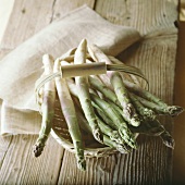 White asparagus with green tips in basket