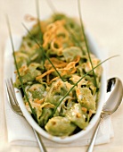 Spinach ravioli with deep-fried onions