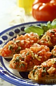 Bruschetta with chopped basil; fresh tomatoes; olive oil