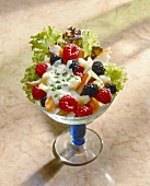 Shrimp salad with berries in glass bowl