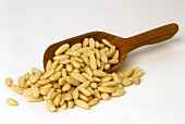 Shelled pine nuts with small wooden scoop