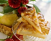 A few pieces of tipsy pear tart on glass plate
