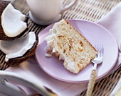 Piece of cloud cake with cream and grated coconut