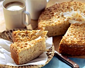 Coconut cake, pieces cut, and coffee