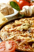 Pizza with mushrooms and tomatoes in baking dish