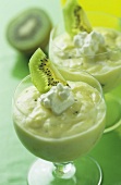 Kiwi fruit mousse with cream in glasses