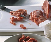 Cutting veal into strips