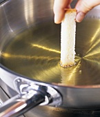 Testing correct oil temperature with piece of bread