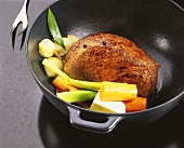 Braising pickled beef (Sauerbraten) with vegetables