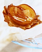 Peach on flaked almonds in baking paper