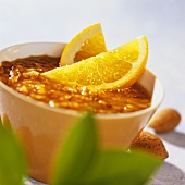 Orange and almond sauce with orange wedges