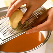 Grating raw potato into sauce (to thicken the sauce)